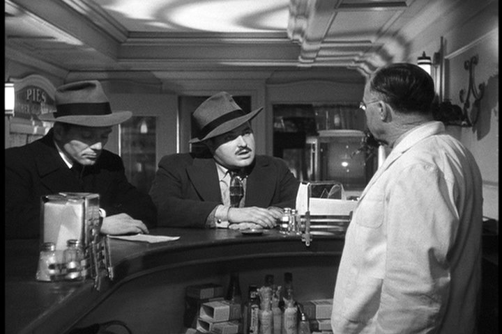 Charles McGraw (left) and Broderick Crawford (center) are the title characters in THE KILLERS